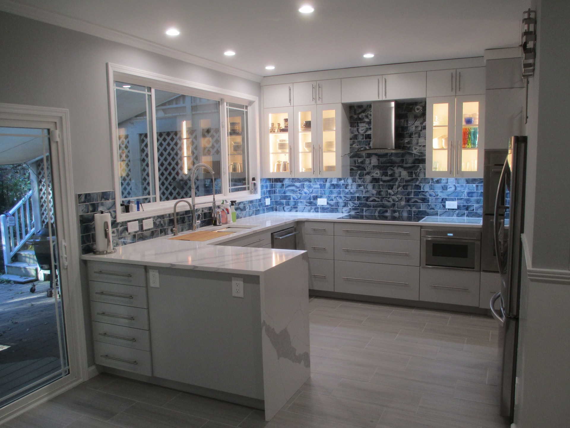 Modern kitchen with blue glass tile backsplash